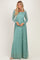 woman wearing a teal long sleeve lace maxi dress with a fitted bodice and flowing skirt