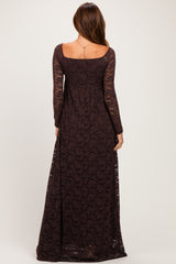 woman wearing a long sleeve dark brown lace maxi dress with a scooped back and flowing silhouette