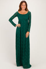 woman wearing a dark green long sleeve lace maxi dress with a scoop neckline and fitted waist