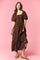 woman wearing a brown puff sleeve maxi dress with white polka dots and a tiered skirt