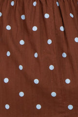 brown maternity dress with light blue polka dots and gathered waist detail