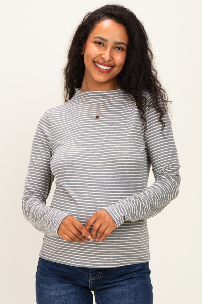 woman wearing a grey and white striped long sleeve maternity top with a round neckline and smiling