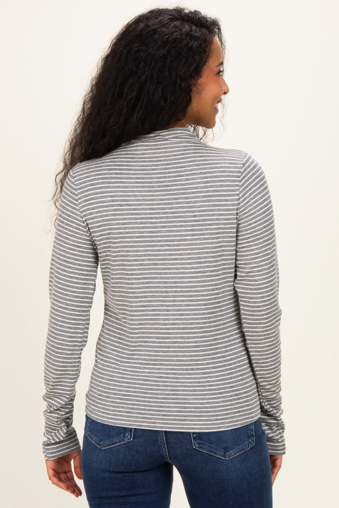 woman wearing a gray and white striped long sleeve maternity top, shown from the back, paired with blue jeans