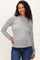 woman wearing a gray and white striped maternity long sleeve top and smiling with a visible baby bump