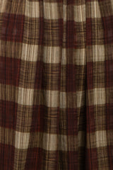maternity wear in a plaid fabric featuring red, brown, and cream colors with a flowing style