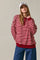 woman wearing a burgundy and striped long sleeve oversized henley top with blue wide-leg jeans and a white cap