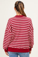woman wearing a red and white striped maternity sweatshirt, showing the back view and relaxed fit