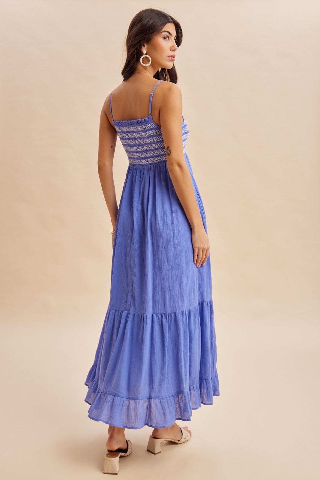 woman wearing a long lavender maxi dress with adjustable straps and smocked bodice, viewed from the back