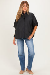 woman wearing a black and checkered maternity shirt with short sleeves and blue jeans