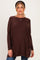 woman wearing a brown maternity sweater with side pockets and a relaxed fit