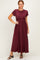 woman wearing a burgundy short sleeve maxi dress with a fitted waist and flowing skirt