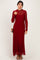 woman wearing a burgundy lace long sleeve maxi dress with a high neckline and a fitted silhouette