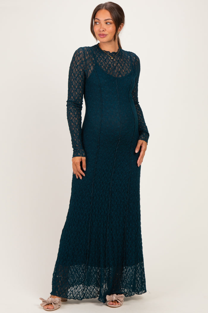 woman wearing a teal lace maternity maxi dress with long sleeves and a fitted silhouette, showcasing her baby bump