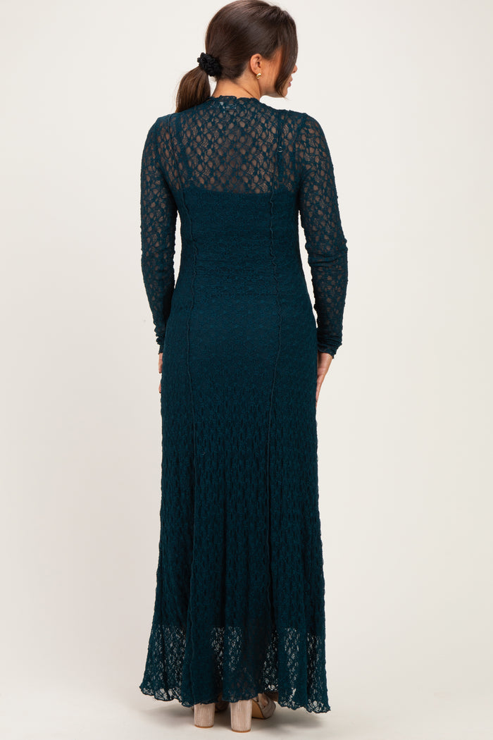 woman wearing a teal lace maternity maxi dress with long sleeves, showing a form-fitting silhouette and flared hem