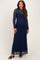 woman wearing a navy lace long sleeve maternity dress with a fitted silhouette and a flowing skirt, showing her baby bump