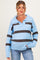 woman wearing a light blue striped maternity sweater with a collared neckline and relaxed fit