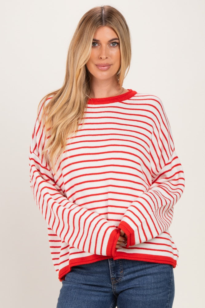 woman wearing a red and white striped oversized sweater with long sleeves and a round neckline