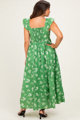 woman wearing a green floral maternity maxi dress with ruffled sleeves and a smocked back