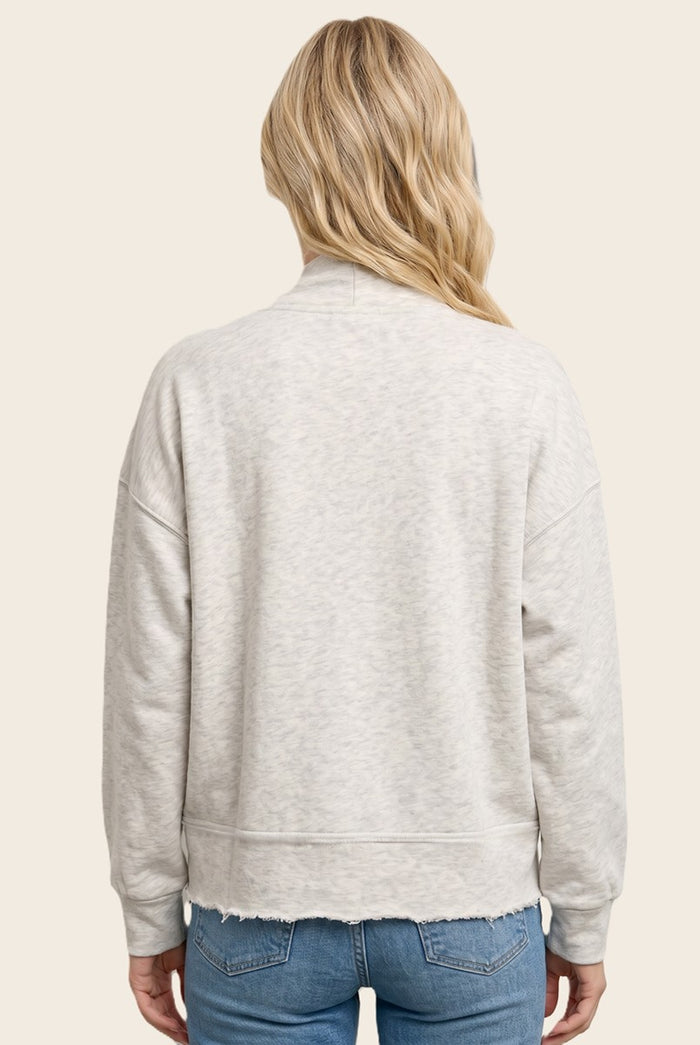 woman wearing a light gray cropped sweatshirt with slouchy shoulders and raw hem, seen from the back