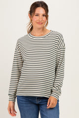 woman wearing a striped maternity long sleeve top with relaxed fit and cozy style, highlighting her baby bump