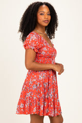 woman wearing a red floral print short sleeve dress with a fitted bodice and flared skirt