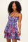 woman wearing a colorful patterned sundress with adjustable straps and a tiered skirt