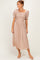 woman wearing a brown polka dot midi dress with puff sleeves and a smocked bodice