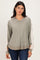 woman wearing a green and beige color-blocked long sleeve hoodie with a loose fit and v-neckline
