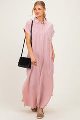 woman wearing a pink button-up maxi shirt dress with short sleeves and two front pockets, carrying a black bag