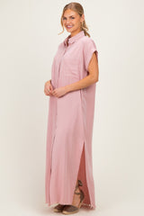 woman wearing a pink short sleeve maxi shirt dress with a front pocket and side slits
