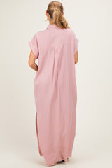 woman wearing a pink maxi shirt dress with short sleeves and a back pleat detail