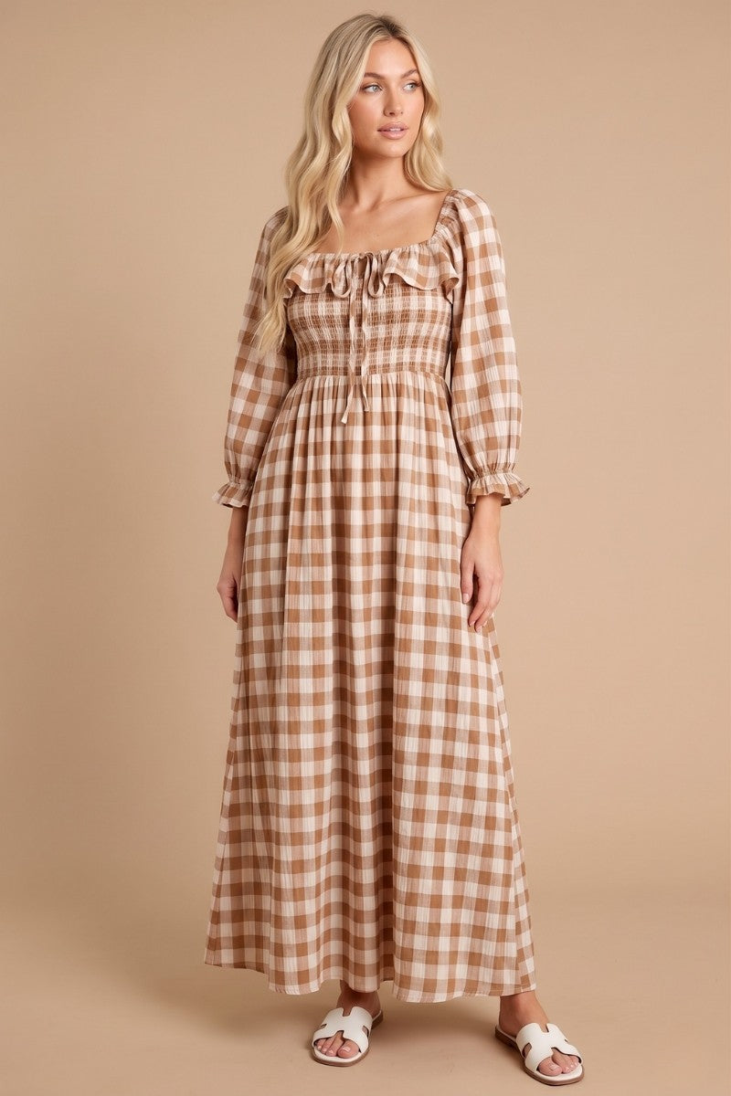 woman wearing a long brown gingham maxi dress with a square neck and puff sleeves