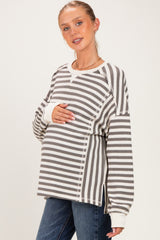 woman wearing a striped maternity sweater with a relaxed fit and a visible baby bump