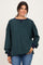 woman wearing a green and navy striped oversized sweatshirt with long sleeves and a relaxed fit