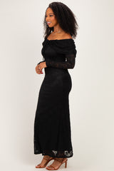 woman wearing a black off-the-shoulder lace maxi dress with long sleeves and fitted silhouette