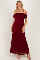 woman wearing a burgundy off-the-shoulder lace maxi dress with ruching detail and thin straps