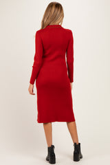 woman wearing a red ribbed midi maternity dress with long sleeves, viewed from the back