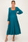 woman wearing a teal maternity dress with a square neckline and long sleeves, showcasing a baby bump