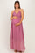 woman wearing a mauve maternity maxi dress with a ruched bodice and sheer overlay, holding her baby bump