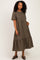 woman wearing a brown checkered tiered midi dress with short sleeves and pockets