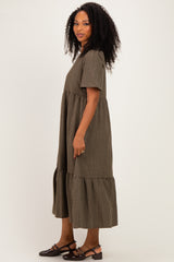 woman wearing a brown and black checkered midi dress with short sleeves and ruffled hem