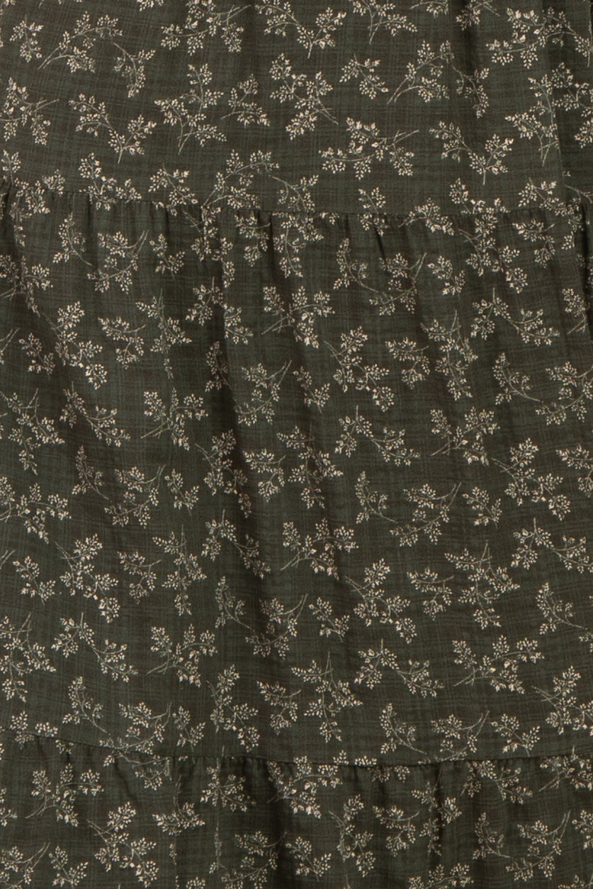 dark green floral tiered dress with subtle patterns and ruffled layers