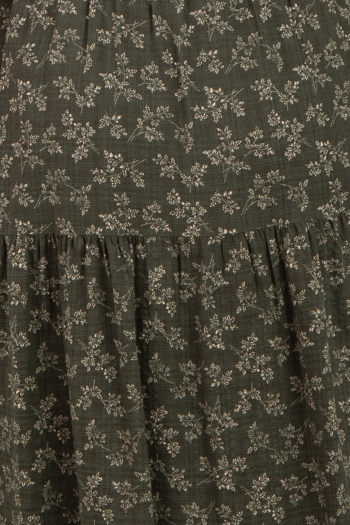 maternity wear in dark green with small floral print and tiered ruffle detailing