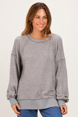 woman wearing a gray ribbed long sleeve sweatshirt with relaxed fit and balloon sleeves