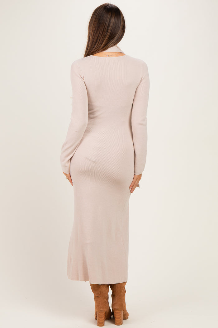 woman wearing a long sleeve ribbed blush pink maternity dress, back view