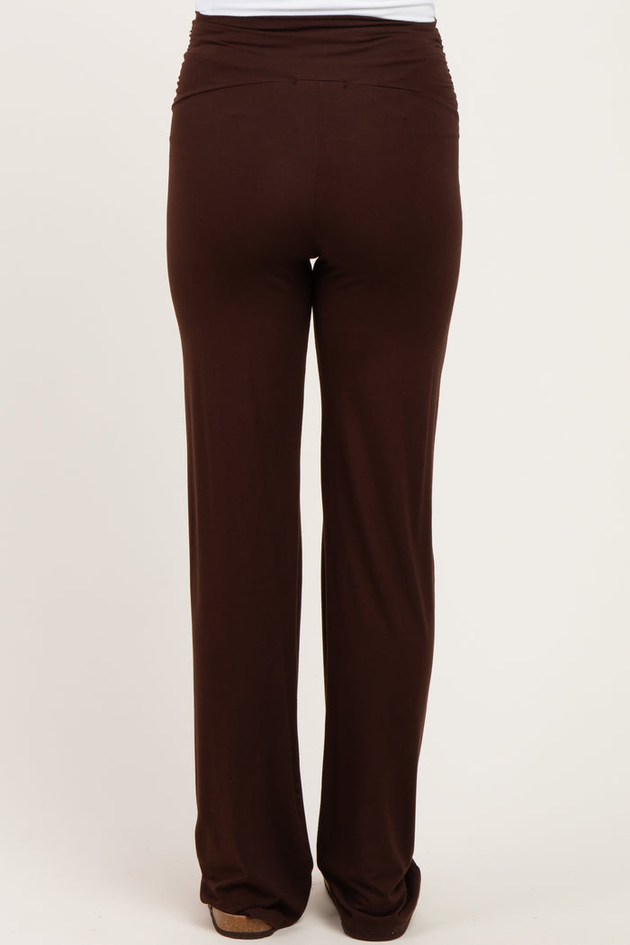 maternity wear brown stretchy pants with a ruched waistband, viewed from the back