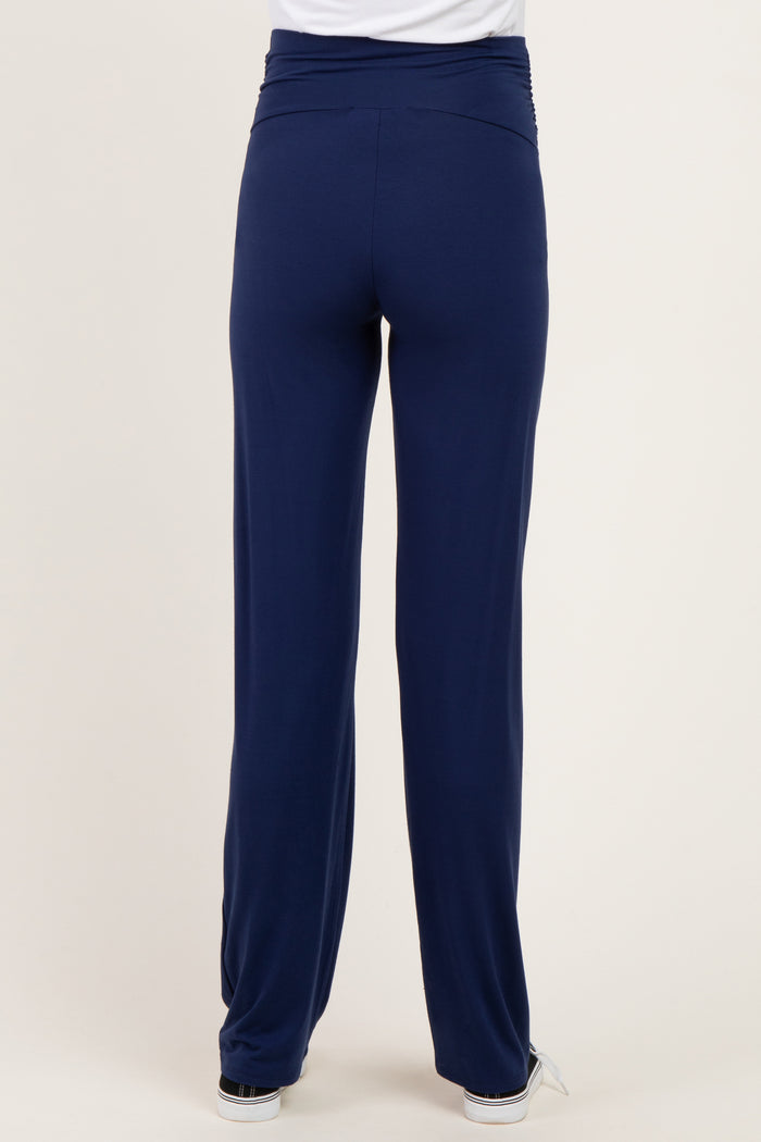 woman wearing navy blue maternity pants with a comfortable waistband, view from the back