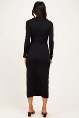 woman wearing a black long sleeve midi dress viewed from the back