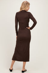 woman wearing a form-fitting brown long sleeve midi dress, shown from the back