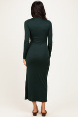 woman wearing a long sleeve dark green maxi dress, viewed from the back